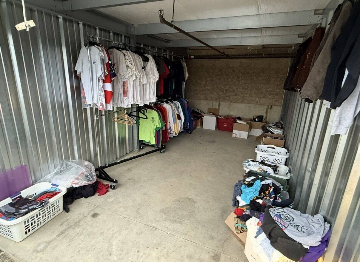 The storage unit two months in: one clothing rack and a few baskets of inventory